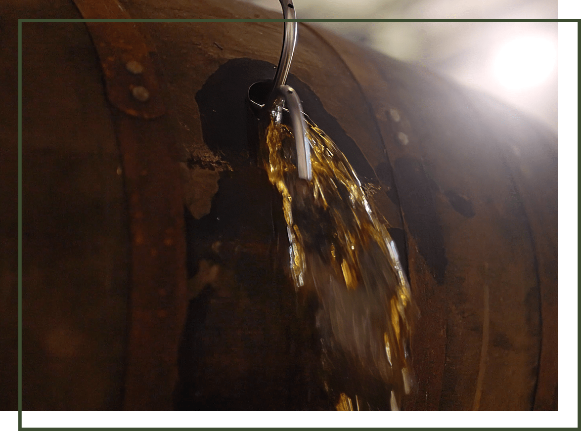 Bourbon being poured out of a barrel